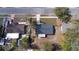 Bird's eye view of a home showcasing a dark roof, screened patio, and tree-lined yard at 4536 San Sebastian Cir, Orlando, FL 32808