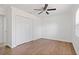 Bedroom featuring wood-look floors, closet, ceiling fan, and natural light at 4536 San Sebastian Cir, Orlando, FL 32808