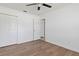 This bedroom features wood floors, a ceiling fan and ample closet space at 4536 San Sebastian Cir, Orlando, FL 32808