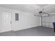 Spacious garage featuring a roll-up door and a separate pedestrian entrance for easy access at 4536 San Sebastian Cir, Orlando, FL 32808