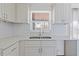 Bright kitchen with stainless steel faucet, new countertops and backsplash at 4536 San Sebastian Cir, Orlando, FL 32808