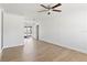 Bright and airy living room with wood-look floors, crown molding, and sliding glass door at 4536 San Sebastian Cir, Orlando, FL 32808