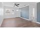 Bright living room featuring wood-look flooring, ceiling fan, and fresh paint at 4536 San Sebastian Cir, Orlando, FL 32808