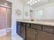 Bathroom boasts a double sink vanity with granite countertops and a tiled shower with glass door at 4594 Terrasonesta Dr, Davenport, FL 33837