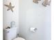 Cozy bathroom with toilet, toilet paper holder, and decorative fish decor at 4594 Terrasonesta Dr, Davenport, FL 33837