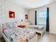 Whimsical bedroom with Mickey Mouse wallpaper, two beds, and natural lighting at 4594 Terrasonesta Dr, Davenport, FL 33837