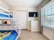 Bedroom features a bunk bed, TV, and plenty of storage space in the dresser at 4594 Terrasonesta Dr, Davenport, FL 33837