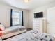 Comfortable bedroom features two beds, a mounted TV, and ample closet space at 4594 Terrasonesta Dr, Davenport, FL 33837