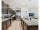 Gourmet kitchen showcasing granite countertops, dark cabinetry, and stainless steel appliances at 4594 Terrasonesta Dr, Davenport, FL 33837