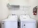 Laundry room featuring a white washer and dryer with a shelf for storage at 4594 Terrasonesta Dr, Davenport, FL 33837
