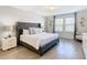 Inviting bedroom with an upholstered bed, natural lighting, and contemporary decor at 4594 Terrasonesta Dr, Davenport, FL 33837