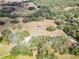 An aerial view of a beautiful vineyard estate, showcasing the lush landscape, solar panels, and serene homes at 5117 Cr 316A, Bushnell, FL 33513