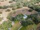 Extensive property with pool, home, vineyards, and mature tree coverage in aerial view at 5117 Cr 316A, Bushnell, FL 33513