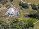Aerial view of a pond area next to a vineyard with trees at 5117 Cr 316A, Bushnell, FL 33513