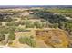 Expansive aerial view showcasing the lush acreage with ponds and mature trees, highlighting the property's serene natural setting at 5117 Cr 316A, Bushnell, FL 33513