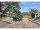 Beautifully landscaped backyard features a charming table and chairs at 5117 Cr 316A, Bushnell, FL 33513