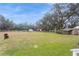 Expansive backyard with multiple sheds, fencing, and mature trees at 5117 Cr 316A, Bushnell, FL 33513