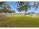 Lush green backyard featuring mature trees and natural irrigation system at 5117 Cr 316A, Bushnell, FL 33513