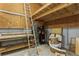 Unfinished basement shows exposed beams and a workbench alongside storage at 5117 Cr 316A, Bushnell, FL 33513