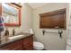 This bathroom features a stylish vanity with a granite countertop, a mirror, and a rustic towel rack at 5117 Cr 316A, Bushnell, FL 33513