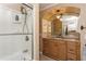Bathroom boasts a glass door shower, vanity with granite countertop, and custom mirror with lighting at 5117 Cr 316A, Bushnell, FL 33513