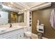 Well-lit bathroom featuring granite countertops, a large mirror, and built-in shelving for storage at 5117 Cr 316A, Bushnell, FL 33513