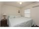 Bright bedroom featuring a queen bed, nightstand with lamp, ceiling fan, and coastal-themed decor, creating a serene ambiance at 5117 Cr 316A, Bushnell, FL 33513