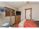 Comfortable bedroom with hardwood floors, a dresser, and natural light from a window at 5117 Cr 316A, Bushnell, FL 33513
