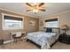 Bright bedroom showcasing a leafy patterned bedspread and a white work desk under a window at 5117 Cr 316A, Bushnell, FL 33513