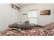 Cozy bedroom with patterned bedding, closet space, and natural light from the window creates a comfortable retreat at 5117 Cr 316A, Bushnell, FL 33513