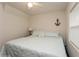 Bright bedroom featuring a queen bed, nightstand with lamp, ceiling fan, and coastal-themed decor, creating a serene ambiance at 5117 Cr 316A, Bushnell, FL 33513