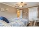 Inviting bedroom with a leafy patterned bedspread, white closet doors and neutral colored walls at 5117 Cr 316A, Bushnell, FL 33513