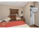 Cozy bedroom featuring rustic window trim, stacked washer/dryer and natural light at 5117 Cr 316A, Bushnell, FL 33513