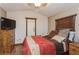Comfortable bedroom with hardwood floors, a dresser, and natural light from a window at 5117 Cr 316A, Bushnell, FL 33513