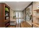 Welcoming entryway featuring a stone accent wall, wood floors, and decorative shelving at 5117 Cr 316A, Bushnell, FL 33513