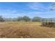Open field with scattered trees and a covered area for livestock at 5117 Cr 316A, Bushnell, FL 33513