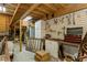 Spacious workshop interior with wooden beams, a utility trailer and natural light, suitable for various projects and storage at 5117 Cr 316A, Bushnell, FL 33513