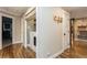Hallway with wood floors, neutral walls, laundry closet, and views into adjacent rooms at 5117 Cr 316A, Bushnell, FL 33513