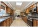 Spacious kitchen features stainless steel appliances, stone countertops, and tiled floor at 5117 Cr 316A, Bushnell, FL 33513