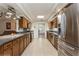 Modern kitchen features stainless steel appliances, granite countertops, and a large island at 5117 Cr 316A, Bushnell, FL 33513