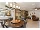 Open living area with stone fireplace, tile floors, and a hanging light fixture at 5117 Cr 316A, Bushnell, FL 33513
