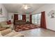 Comfortable living room features laminate flooring, large windows, and comfortable seating at 5117 Cr 316A, Bushnell, FL 33513