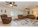 Comfortable living room featuring tile floors, ceiling fans, and large windows at 5117 Cr 316A, Bushnell, FL 33513