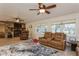 Comfortable living room with ceiling fans, stone fireplace, and lots of natural light at 5117 Cr 316A, Bushnell, FL 33513