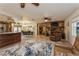 Open living area with tile floors, a stone fireplace, and access to the kitchen and dining room at 5117 Cr 316A, Bushnell, FL 33513