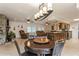 Open living area with stone fireplace, tile floors, and modern lighting fixtures at 5117 Cr 316A, Bushnell, FL 33513