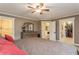 Comfortable main bedroom with an elegant ceiling fan and convenient access to the closet and bathroom at 5117 Cr 316A, Bushnell, FL 33513