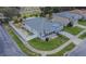 An aerial view of a house with a manicured lawn and a white picket fence at 523 Cascading Creek Ln, Winter Garden, FL 34787