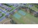 Aerial view of community tennis and basketball courts surrounded by residential homes at 523 Cascading Creek Ln, Winter Garden, FL 34787