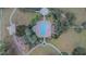 Aerial view of the community pool, surrounded by lush landscaping and convenient walkways and playground at 523 Cascading Creek Ln, Winter Garden, FL 34787